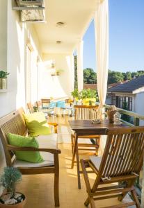 a patio with a table and chairs on a balcony at Spacious apartment by the sea 8+4 in Pula