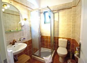 a bathroom with a shower and a toilet and a sink at Akti Kamares in Kamáres