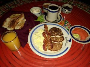 a table topped with a plate of food and a cup of coffee at Hotel el Fuerte in El Fuerte