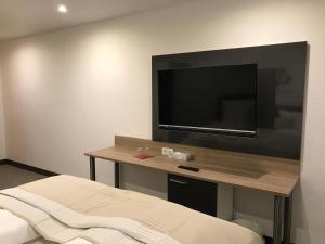 a hotel room with a flat screen tv on the wall at Pension Scheiber Hof in Neunkirchen