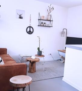 a living room with a couch and a table at INTIKA Beach House in Zandvoort