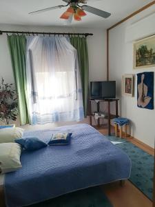 a bedroom with a blue bed and a window at Apartment Jablanac 1 in Jablanac