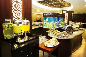 a buffet line with food and drinks in a restaurant at Al Thuraya Hotel in Amman