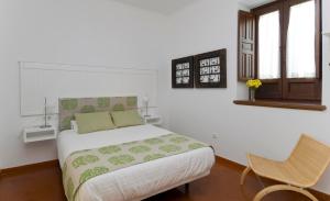 1 dormitorio con 1 cama y 1 silla en Entre2mezquitas 6, en Córdoba