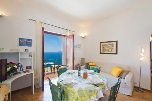 a living room with a table and a couch at Mon Amour Praiano in Praiano