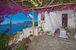 a patio with flowers and a view of the water at Mon Amour Praiano in Praiano