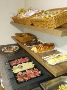a bunch of different types of food on shelves at Hotel Nès Crépes in Pozza di Fassa