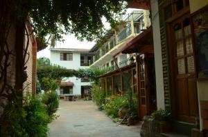 un patio de un edificio con flores y plantas en Hostal Pachamama, en Sucre