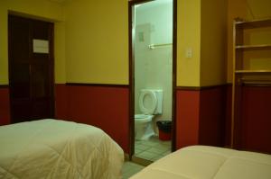 Posteľ alebo postele v izbe v ubytovaní Hostal Pachamama