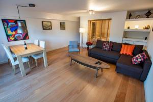 a living room with a couch and a table at Central & Quiet Canal Apartment in Amsterdam