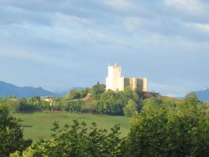 a large white building on top of a green field at Résidence Le Beau Site in Capvern