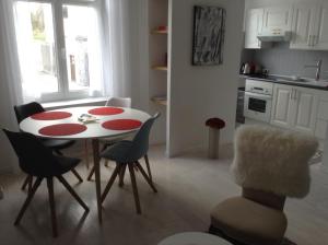 a kitchen with a table and chairs in a room at Le Bellevue in Wimereux
