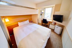 a hotel room with a bed and a television at Super Hotel Ogaki Ekimae in Ogaki +22 photos