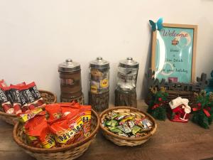 a table with three baskets of food and christmas gifts at Vrest Hotel in Malacca