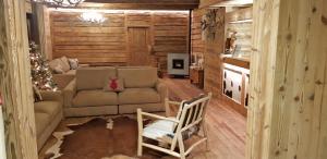 a living room with a couch and a christmas tree at Hotel La Rouja in Champoluc