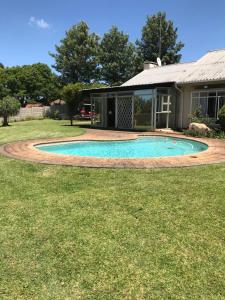 a swimming pool in the yard of a house at Ian and Pam's Flatlet in Empangeni