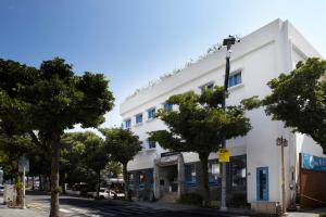 a white building on the side of a street at Olle Stay in Seogwipo