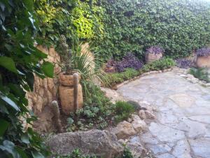a garden with a stone path and plants at Hotel Sant Jordi in Tarragona