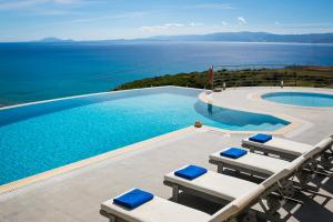 a swimming pool with a view of the ocean at Kaminia Blu in Ratzaklíon