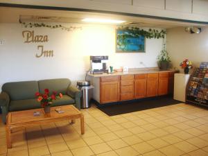 a waiting room with a couch and a coffee table at Plaza Inn in Topeka