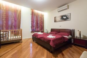 a bedroom with a bed and a crib at Apartments City Wellness Center in Zagreb