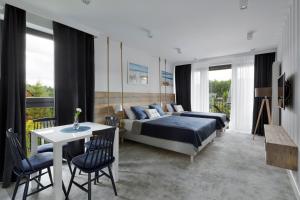 a bedroom with a bed and a table and chairs at Klonova in Białogóra +49 photos