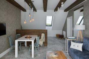 a living room with a table and a couch at Klonova in Białogóra