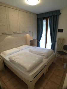 Postel nebo postele na pokoji v ubytování Residence Cima Tosa