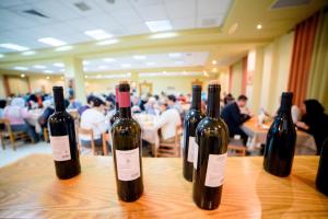 four bottles of wine sitting on top of a table at Sancta Maria Hotel in Bethlehem