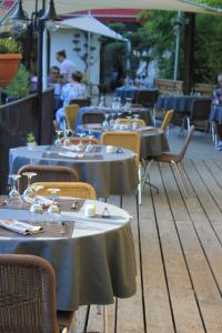 a row of tables and chairs at a restaurant at Le Belvedere in Vallon-Pont-dʼArc