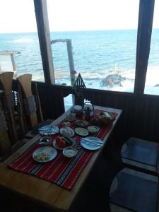 a table with food on it with a view of the ocean at Lavash Hotel in Sevan
