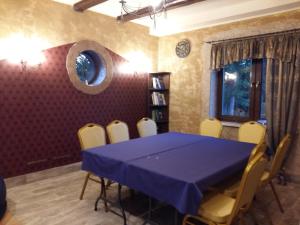 a dining room with a blue table and chairs at Chillout-House in Mińsk Mazowiecki