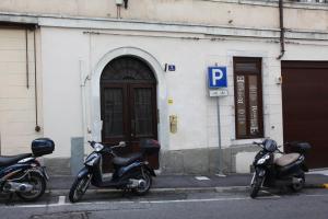 two motorcycles parked in front of a building at Residence Nove in Trieste