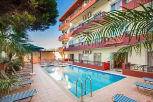 a swimming pool in front of a hotel at Alea Hotel Apartments in Ialysos
