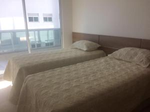 Postel nebo postele na pokoji v ubytování LE BON VIVANT - LINDO APARTAMENTO PRAIA GRANDE + 14 fotografií