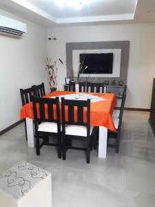 a dining room with an orange table and chairs at Aires de Maipu in Maipú