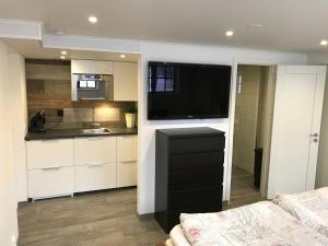 a kitchen with a large television in a room at Residence Marmorvägen in Karlstad