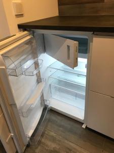 an empty refrigerator with its door open in a kitchen at Residence Marmorvägen in Karlstad