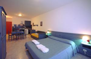 a bedroom with a bed and a living room at Residence Borgo San Sebastiano in Bergeggi