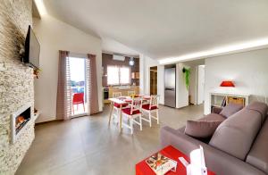 a living room with a couch and a dining room at Residence Dei Viali in Ragusa