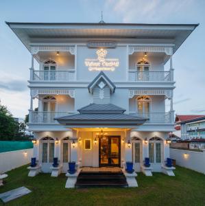 a large white house with a front entrance at The Velvet Orchid in Chiang Mai