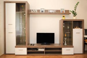 A television and/or entertainment centre at Yellow apartment few steps from metro