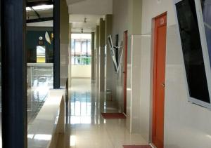 an empty hallway of a building with a door and a hallway at Tirta Kencana Baturraden in Baturaden