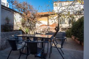 a table and chairs on a patio at Portas De São Bento Apartments in Lisbon