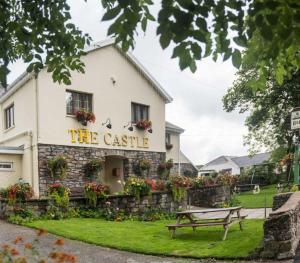 a building with a bench in front of it at The Castle Inn in Ebbw Vale