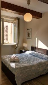 a bedroom with a large bed and a window at Heart of Parma in Parma