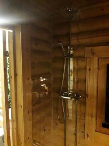 a glass shower in the corner of a room at Temola in Alvajärvi
