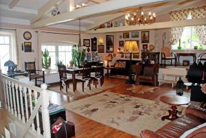 a living room filled with furniture and a dining room at Appartementhaus zur Brücke direkt am See in Sandort