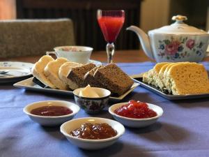 a table topped with plates of bread and dipping sauces at Evergreen in La Cumbre