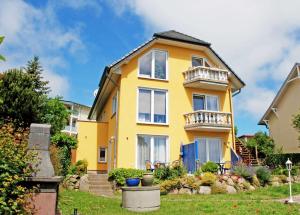 ゲーレンにあるFerienwohnungen Haus Inselblick miの黄色の家 バルコニー2つ付